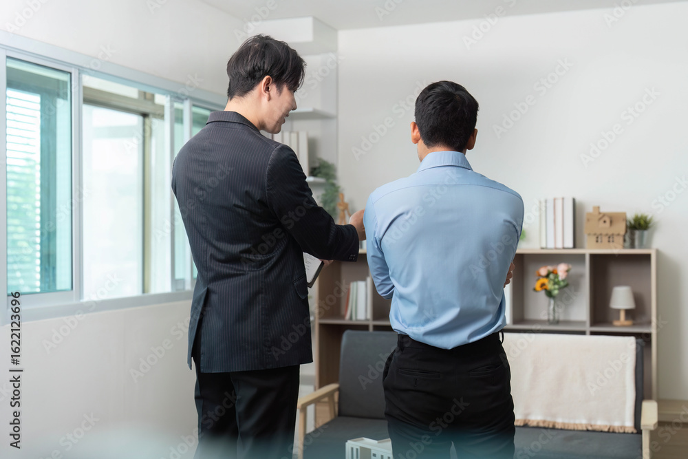 Fototapeta premium Business Meeting. Two professionals discussing project details in a modern office.