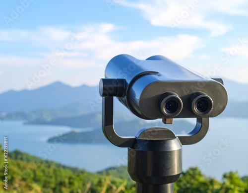 Coin-operated tourist binoculars with a metal telescope lens for viewing the city landscape against a blue sky