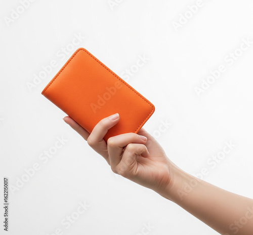 hand holding a red book