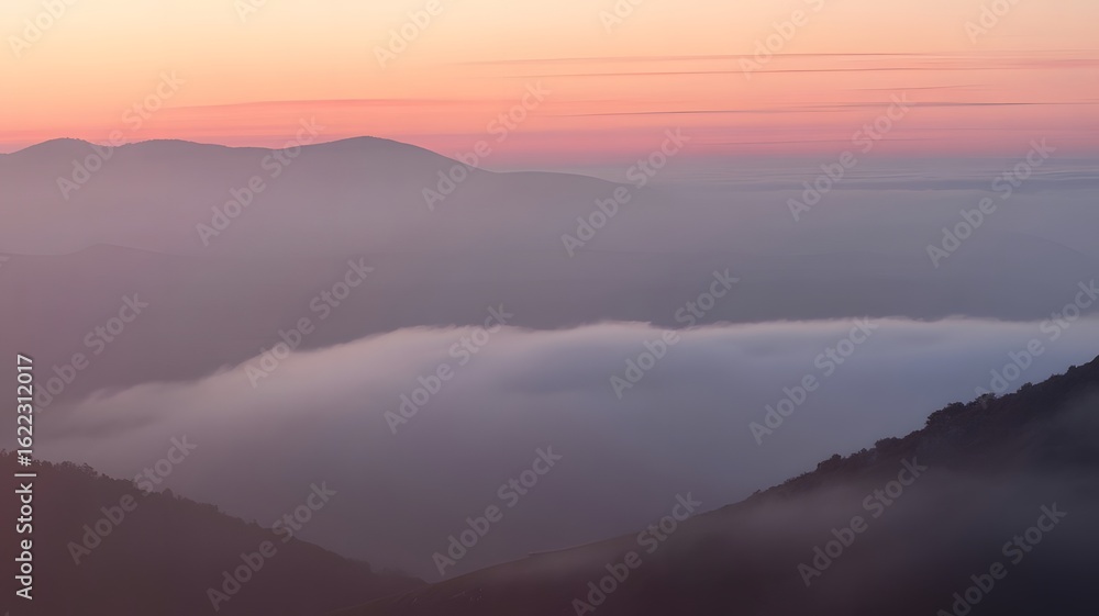 Fototapeta premium Serene mountain landscape at dawn with soft pink sky and a sea of clouds below