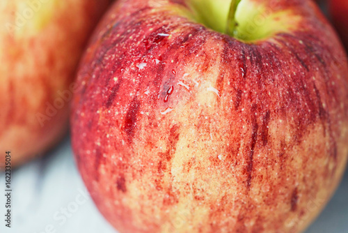 Close up of fresh red apple with water drops.