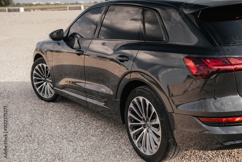 Premium electric SUV in gray with black chrome trim and large wheels.