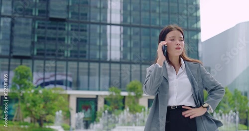 Worried Businesswoman Checking Time While Waiting Outdoors
