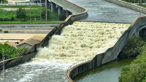 Aerial drone view of the Water Transfer Bridge draining floodwater across canals and roads, with a flume and pumping station accelerating flow to the sea, effectively reducing flood risks.
