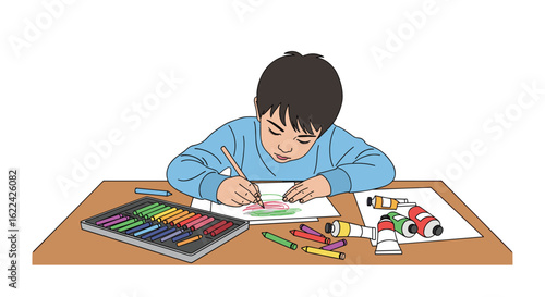 A young boy concentrates diligently while drawing and coloring a picture on a desk with art supplies nearby