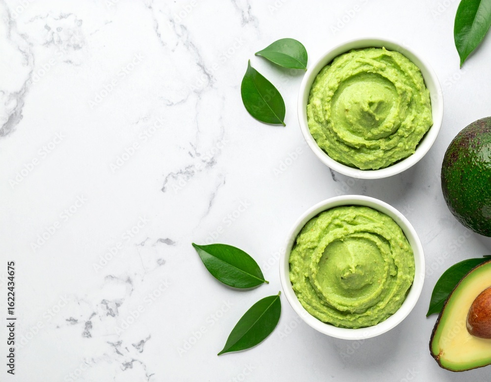 Obraz premium Overhead shot of avocado mousse in white bowl, wide composition with space for text. Fresh, creamy, and healthy, perfect for dessert, vegan, and food photography projects.