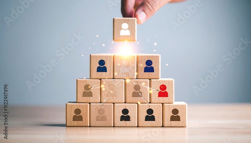 Wooden blocks forming a pyramid with people icons