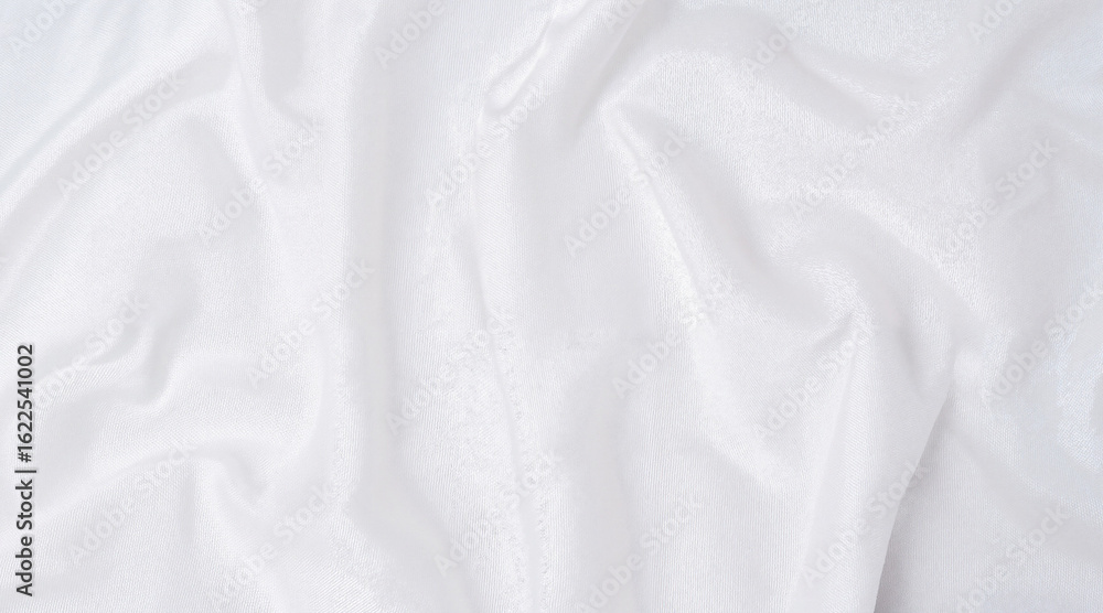 Fototapeta premium White wrinkled fabric draped softly on a flat surface 