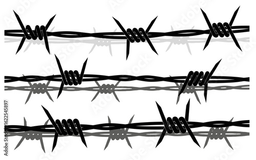 Three rows of black barbed wire with gray shadows sharp and dangerous