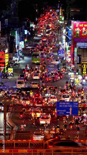 Wallpaper Mural Busy traffic jam during sunset and colorful perspective of Dien Bien Phu St with numerous hotel, bar and shop sign boards, crowded with people, motorbikes Torontodigital.ca
