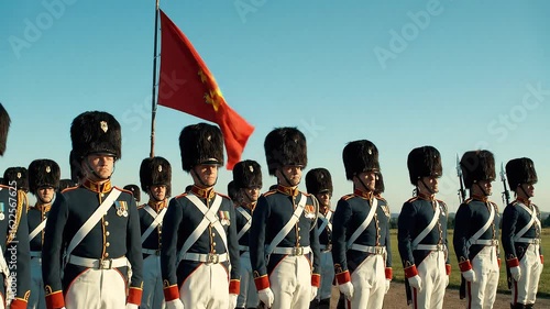Royal Guardsmen in Formal Uniform Standing in Formation Under a Flag at a Military Parade