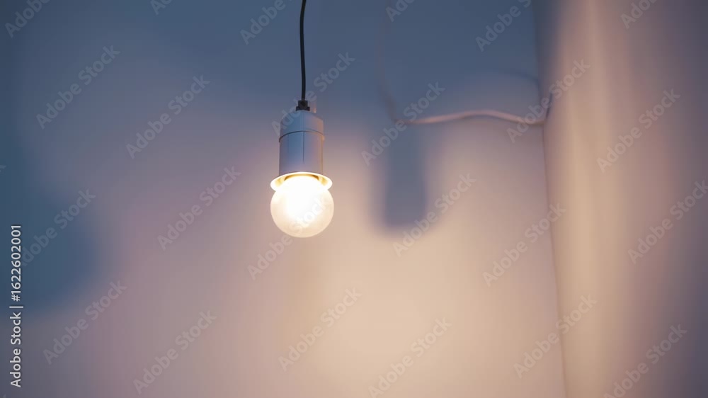 Closeup of Warm Light Bulb Illuminating a Softly Colored Ceiling Scene Closeup of Warm Light Bulb Illuminating a Softly Colored Ceiling Scene