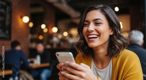 young woman texting on mobile phone in cafe