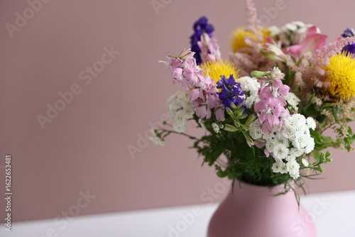 Wallpaper Mural Beautiful flowers in vase on white table against pink background, closeup. Space for text Torontodigital.ca
