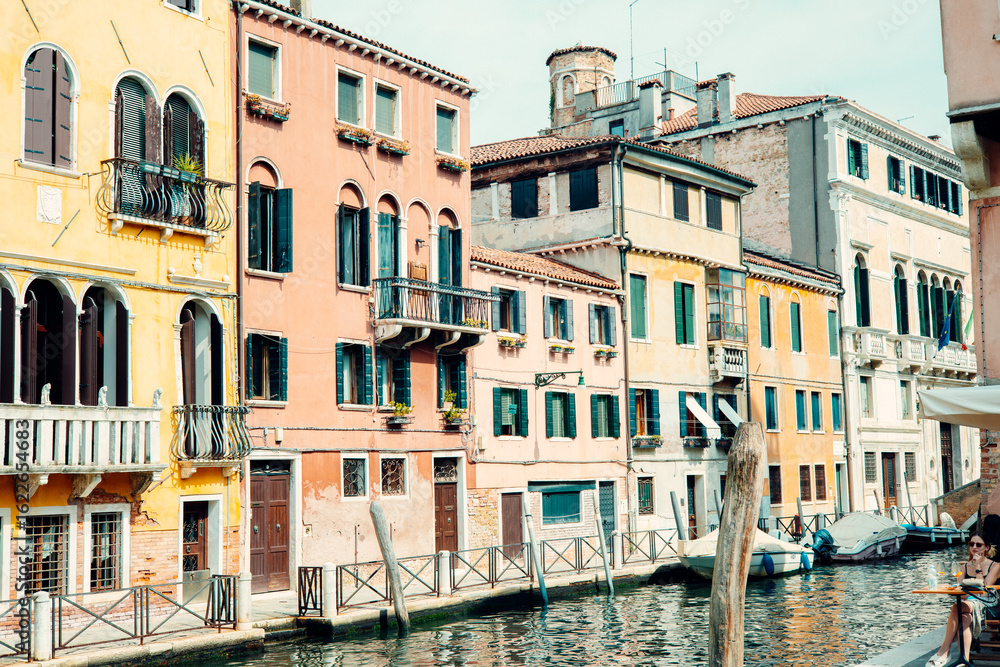 Colorful buildings lining a canal in venice, italy, are reflecting in the water Colorful buildings lining a canal in venice, italy, are reflecting in the water