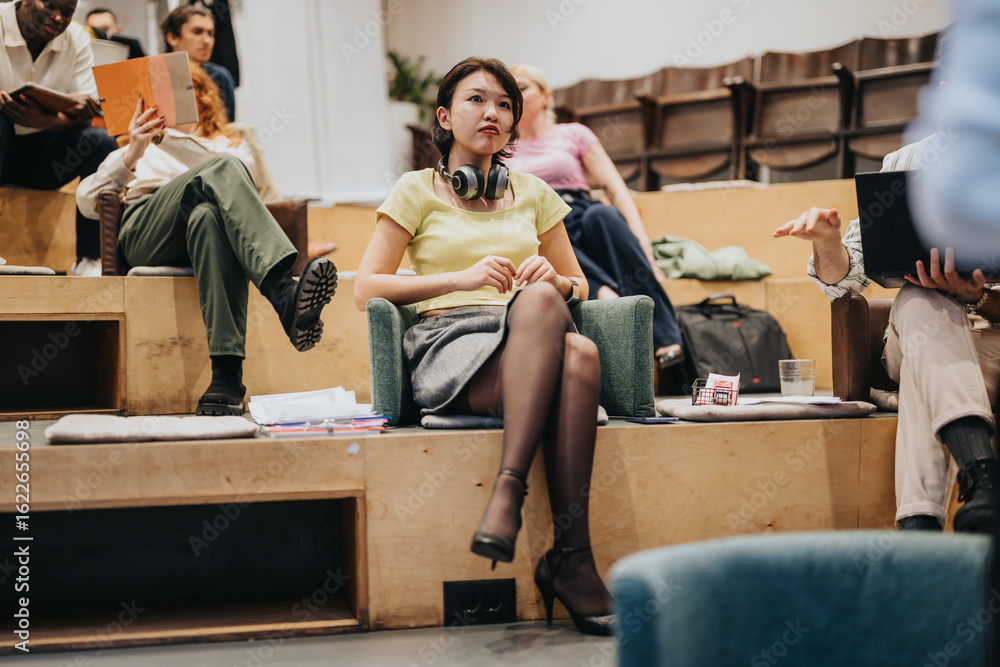 Fototapeta premium Creative environment capturing young individuals actively engaging in a brainstorming session during a business meeting, promoting teamwork and creative thinking in a stylish contemporary auditorium.