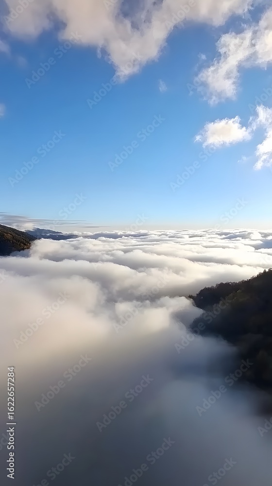 Fototapeta premium Stunning Aerial View of Mountains Above Cloudscape