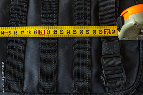 Measuring the backpack size with a tape measure before traveling by plane, permissible dimensions of hand luggage for airplanes in Europe