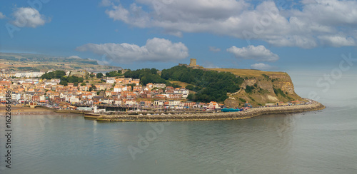Aerial photo of Scarborough seafront and castle. Scarborough is a seaside town and civil parish in the district and county of North Yorkshire, England. With a population of 61,749
