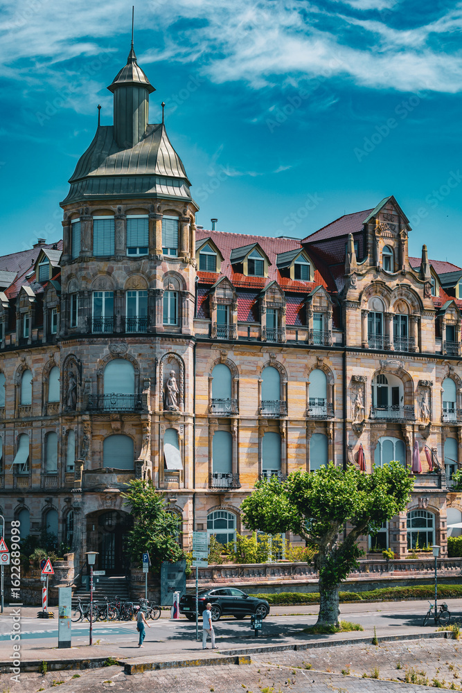 Naklejka premium Panoramic view of beautifully preserved Art Nouveau and historic buildings along the Rhine River in Konstanz Germany. The colorful facades and ornate architecture create a charming cityscape on a brig