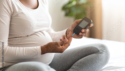 Pregnant Woman Monitoring Blood Glucose Levels at Home