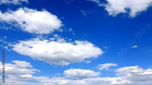 A vast blue sky dotted with fluffy white clouds