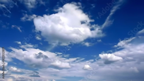 A vast expanse of blue sky dotted with fluffy white clouds