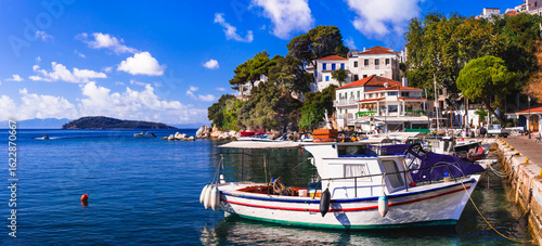 Fototapeta Naklejka Na Ścianę i Meble -  Greece, Sporades, beautiful Skiathos island, traditional fishing boats in charming old town in the morning light. greek vacation and tourism