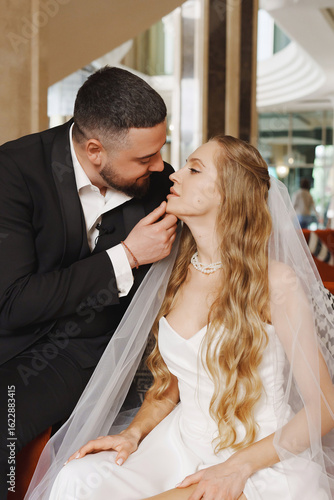 happy bride and groom in the lobby of the hotel on the day of the wedding