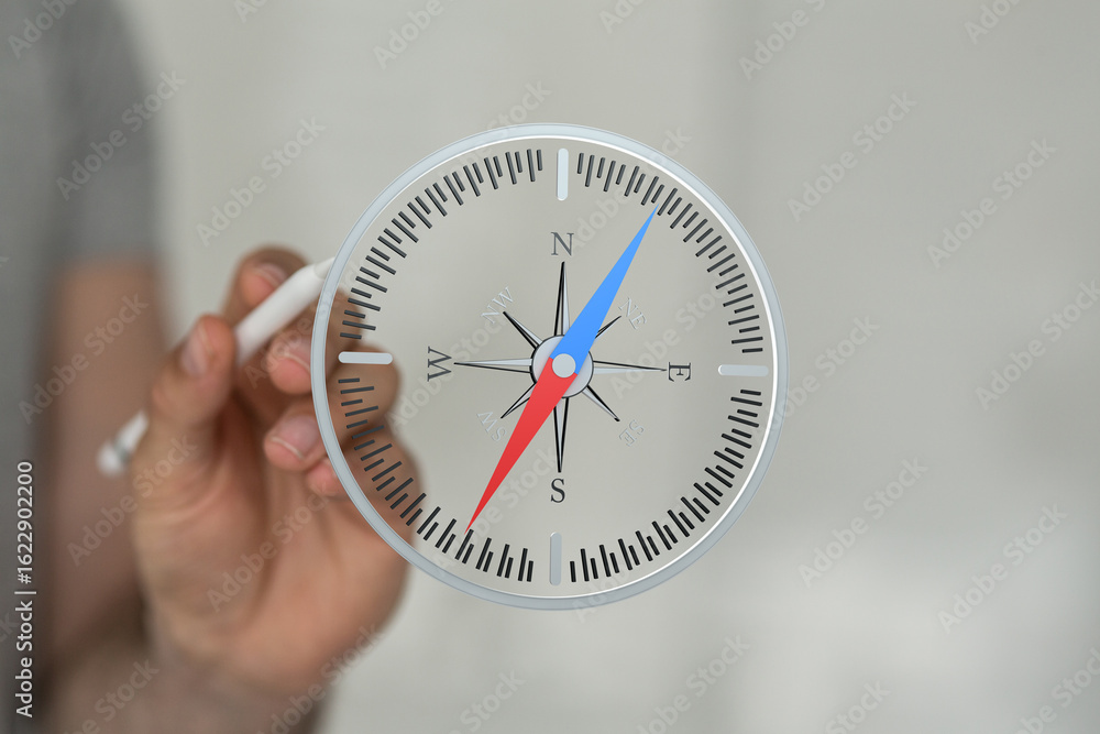 Stock photo of a hand holding a digital compass, showing north, south, east, and west directions. Stock photo of a hand holding a digital compass, showing north, south, east, and west directions.