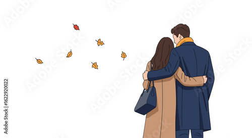 Couple enjoying autumn leaves falling during a romantic walk together