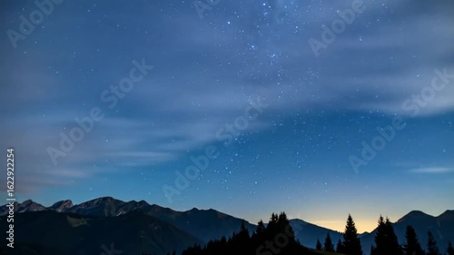 Wallpaper Mural Dramatic Night Sky with Starry Display over Silhouetted Mountain Range with Trees in the Foreground Ethereal Scene Torontodigital.ca
