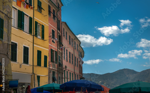 fragment of buildings with warm colors of facades and umbrellas, Italian seas...
