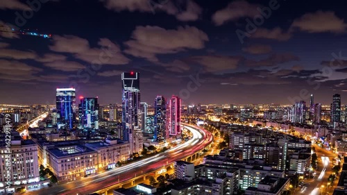 Wallpaper Mural Urban development and transportation infrastructure are highlighted in Tel Aviv as day transitions into night, showcasing the city's dynamic energy and vibrant atmosphere Torontodigital.ca