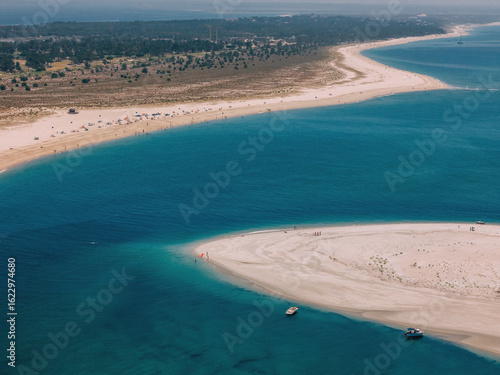 Scenic view of Troia beach and coastline in Portugal on a sunny day with clear waters and sandy shores