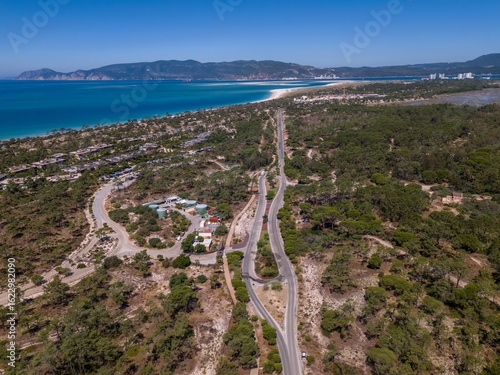 Expansive view of Troia Portugal showcasing winding roads and sandy beaches under clear blue skies