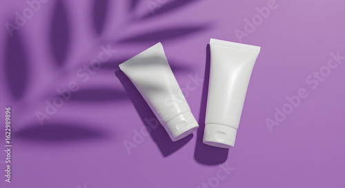 Wallpaper Mural Two blank white tubes of cosmetic cream on purple background with leaf shadow for your branding design and mockup needs. Torontodigital.ca