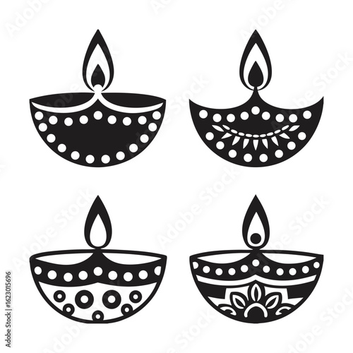 A collection of four black and white diyas, each adorned with unique decorative patterns, displayed side by side