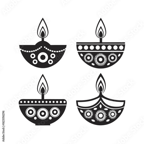 A collection of four black and white diyas, each adorned with unique decorative patterns, displayed side by side