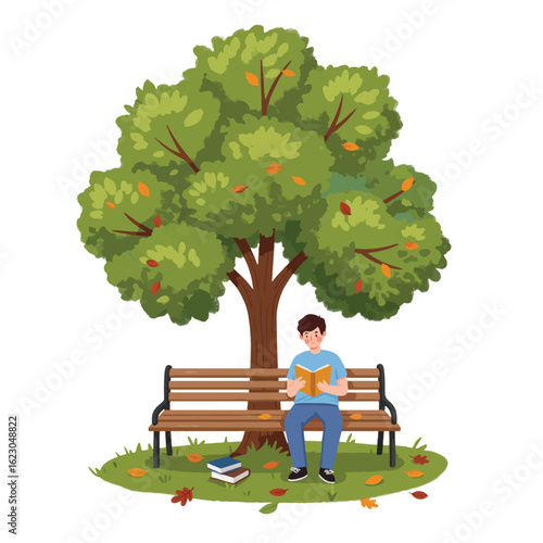 Young man peacefully reading a book on a park bench under a large tree in autumn.