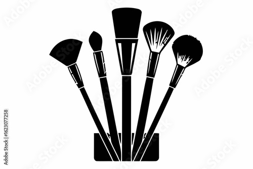 Collection of makeup brushes in a holder silhouette isolated on white background