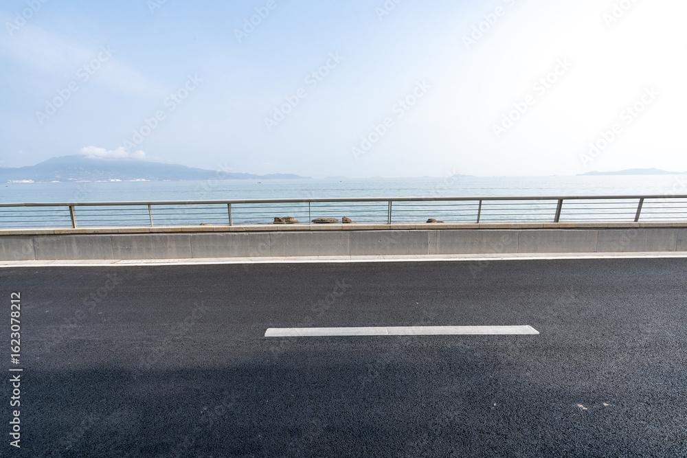 Fototapeta premium asphalt road side by sea