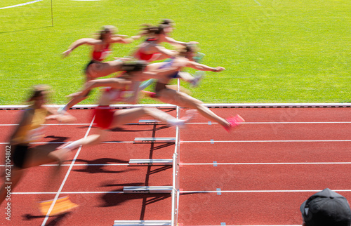blurred image of women crossing the hurdles
