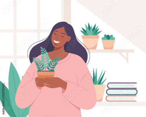 A smiling woman in a cozy room enjoying her hobby of caring for a potted fern plant.