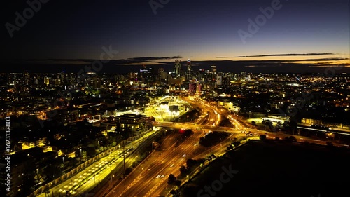 Wallpaper Mural 4K Aerial Night hyperlapse Perth City, with car traffic transport across Graham Farmer Freeway or winding road expressway in Perth City, drone aerial view, high angle, Western Australia Torontodigital.ca
