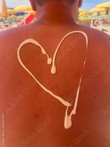 Heart Shaped Sunscreen 50+ SPF on the back of a Tourist on the Beach