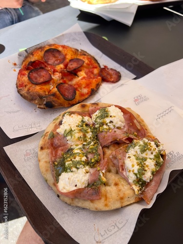 Mini Italian Pizza with Pepperoni and Mozzarella and Pistachio Cream. Classic Italian Restaurant