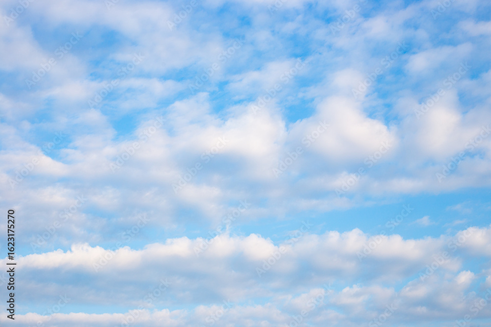 A wide expanse of blue sky with fluffy white clouds, creating a serene and peaceful scene A wide expanse of blue sky with fluffy white clouds, creating a serene and peaceful scene