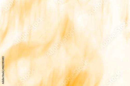 Abstract fiery orange and yellow streaks against a dark background evoking the dynamic and intense nature of flames