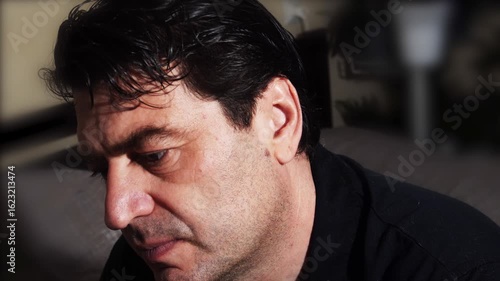 A man is stressed after receiving a video of his wife cheating on him.
